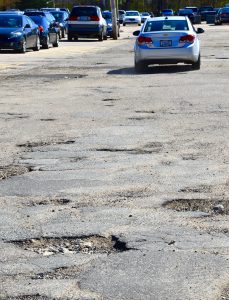 Jon Brock | Cars maneuver around potholes in the Fine Arts Center parking.