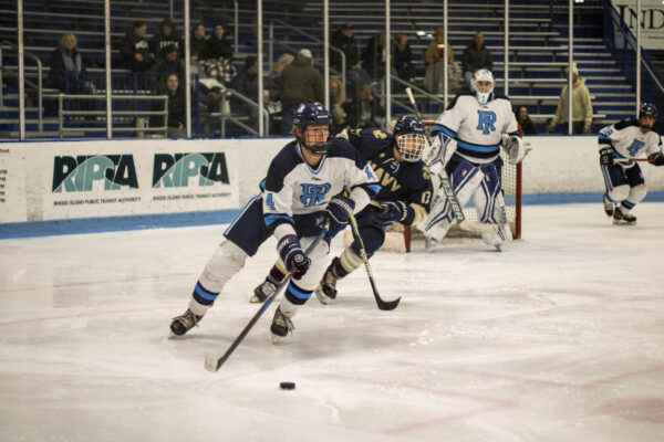 Third-year forward Zach Bell drives with the puck versus the United States Naval Academy. PHOTO CREDIT: Sky Connor | Staff Photographer