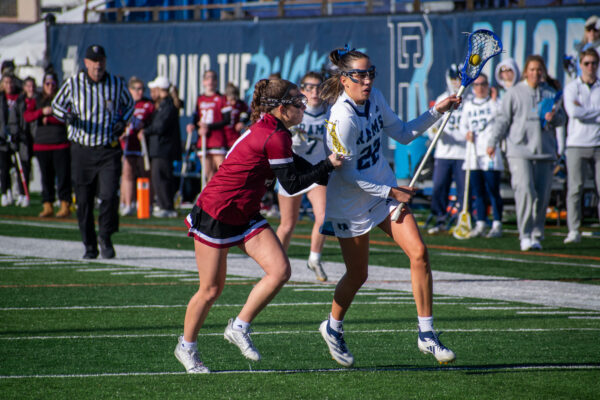 Second-year midfielder Brinley Myers runs past a Rider defender. PHOTO CREDIT: Nora Kelley | Photo Editor