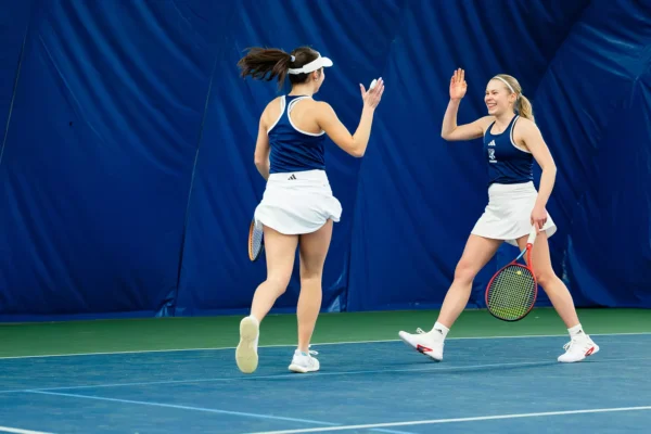 Third-year Sophie Herrman and fourth-year Klara Nelander celebrate their win against Sacred Heart on Feb. 23. PHOTO CREDIT: Michael Larkin / GoRhody.com