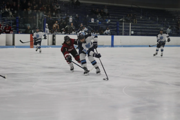 Second-year defenseman Penny Spack dodges a UMass defender. PHOTO CREDIT: Sky Connor | Staff Photographer