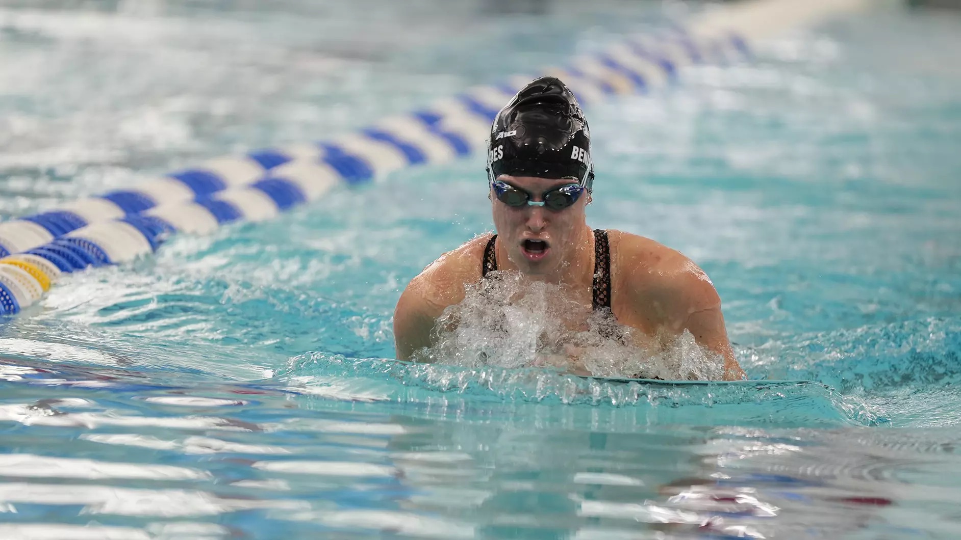 Fourth-year swimmer Hannah Benavides places sixth in the 200-Yard Breaststroke at the A10 Championship. PHOTO CREDIT: GoRhody.com