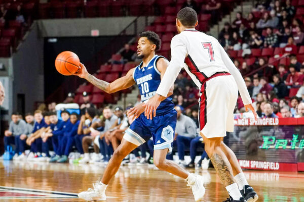 Third-year guard Jamarques Lawrence looks to pass the ball to a teammate against UMass. PHOTO CREDIT: Josh Paiva / GoRhody.com