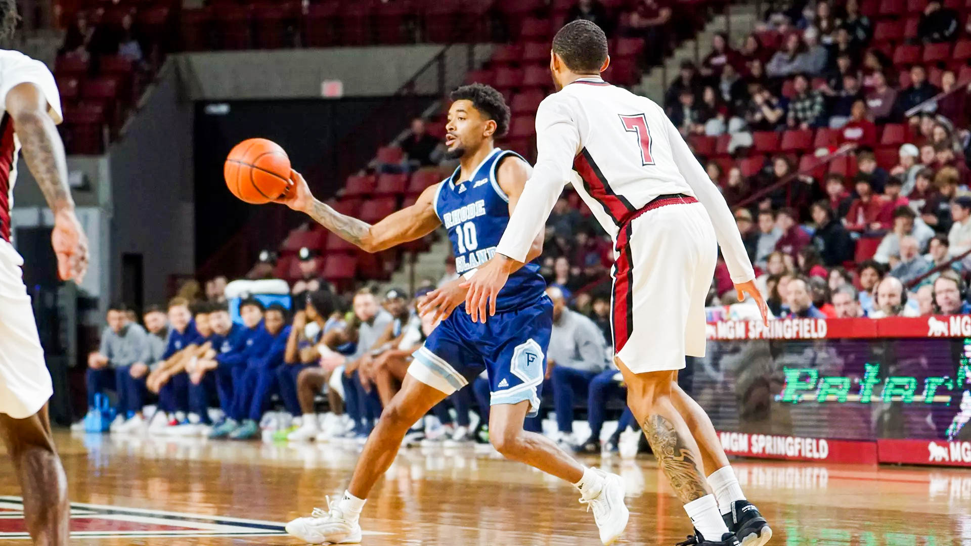 Third-year guard Jamarques Lawrence looks to pass the ball to a teammate against UMass. PHOTO CREDIT: Josh Paiva / GoRhody.com