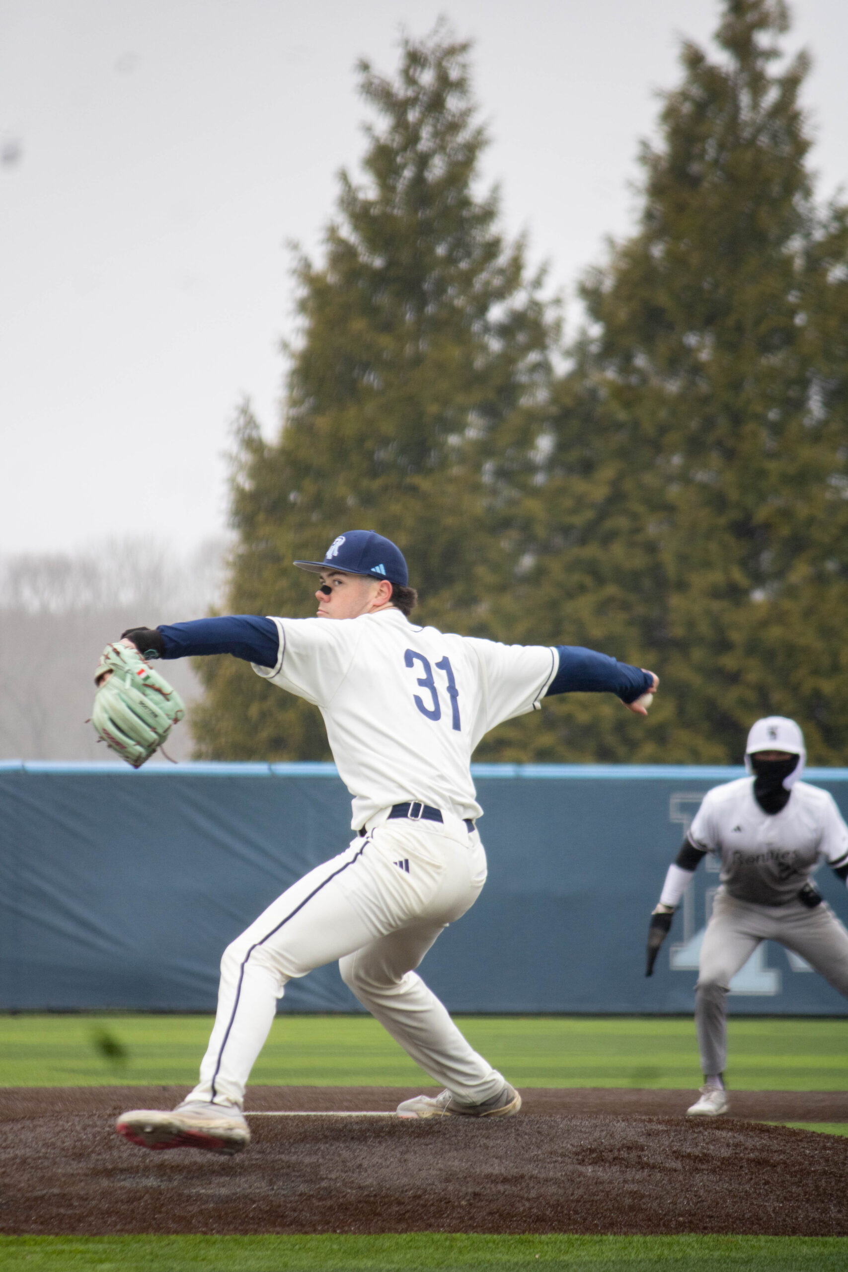 First-year Jake Cullen strides as he winds up to deliver a pitch to a St. Bonaventure batter. PHOTO CREDIT: Skylar Connor | Staff Photographer