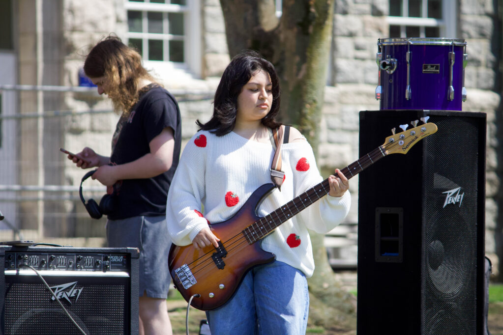 PHOTO CREDIT: Skylar Connor | Staff Photographer
A student pets a goat from Peckham Farm.
A student from a Musicians Guild band performs on the quad during URI’s earth day celebration.
Student vendors sell different pieces of art on the quad.